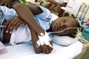 A Cholera outbreak originating in the Central Artibonite region of Haiti has killed around 250 people and effected over 2500 in the region.  A young girl with Cholera lies on a cot in the courtyard of the overcroweded L'Hopital St. Nicholas in St. Marc, the center of the Cholera epidemic, where Medecins Sans Frontiere and Cuban doctors are treating those infected.  Photo MINUSTAH/Sophia Paris